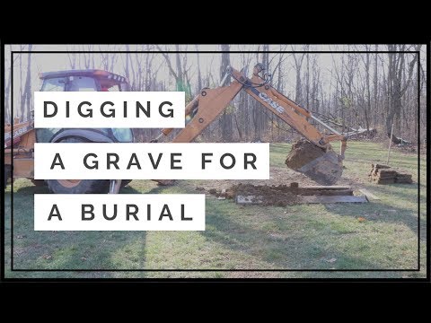 Digging a grave for a burial at a cemetery